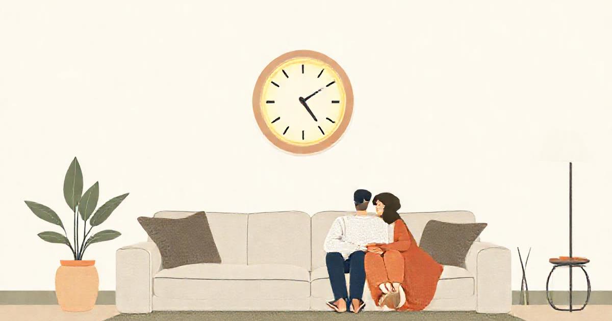 A living room wall with a softly glowing ring gauge, a couple on the sofa.