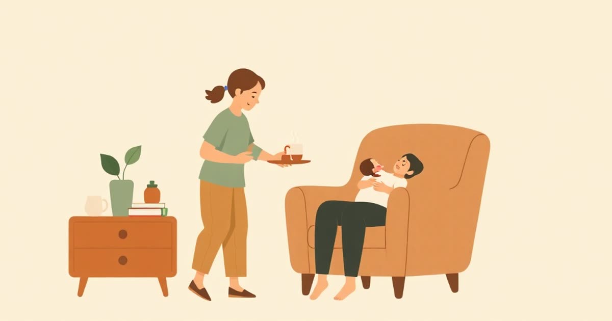 A partner bringing a tray of food and water to a parent nursing a newborn in a cosy armchair.