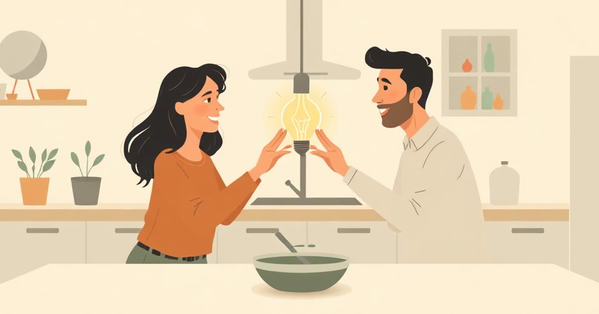 Two people passing a glowing lightbulb between them over a kitchen table.