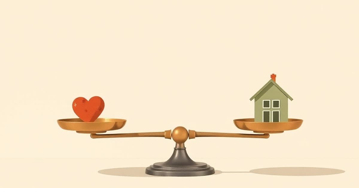 A balanced brass scale on a table holding a small heart on one pan and a tiny house on the other, nothing else in the scene.