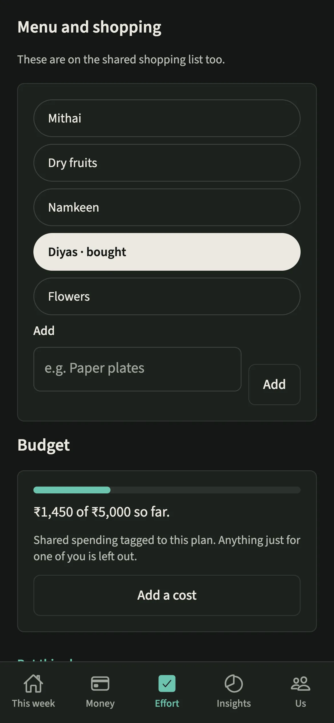 The menu and shopping list of a Diwali plan in EvenUS dark mode with sweets, dry fruits and diyas, one item marked bought